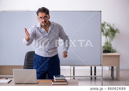 Young male teacher in the classroom 86062689