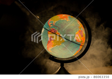 Glowing globe in the dark among the fog. 86063350