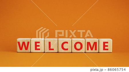 Welcome and support symbol. The concept word Welcome on wooden cubes. Beautiful orange table, orange background, copy space. Business, welcome and support concept. Welcome and support symbol. The concept word Welcome on wooden cubes. Beautiful orange table, orange background, copy space. Business, welcome and support concept. 86065754