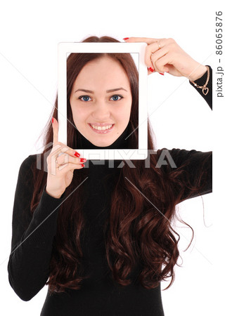 Portrait smiling teenage girl with digital tablet making selfie 86065876