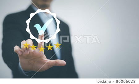 Quality assurance of business services and five star, Businessman hand shows the sign of the top service Quality assurance, Guarantee, Standards, ISO certification and standardization concept. 86066028