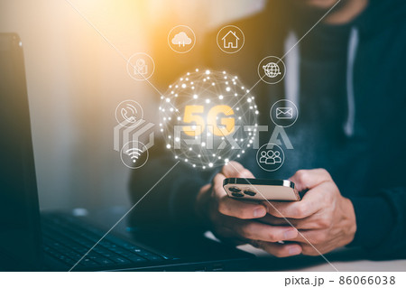 Man hold smartphone with Global network connection 5G virtual interface screen on laptop device, 5G mobile concept, technology network wireless systems and internet of things,high speed internet. Man hold smartphone with Global network connection 5G virtual interface screen on laptop device, 5G mobile concept, technology network wireless systems and internet of things,high speed internet. 86066038