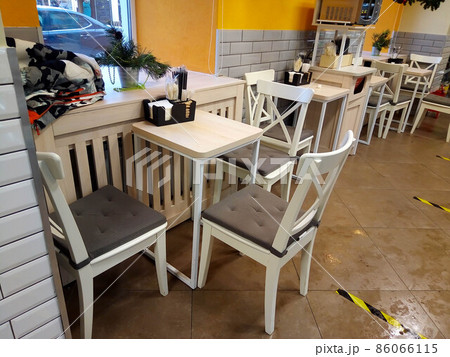 Coffee shop interior design white tables chairs and yellow walls 86066115