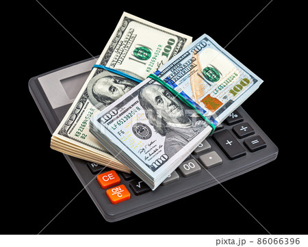 American dollar banknotes with calculator on a black background. American dollar banknotes with calculator on a black background. 86066396
