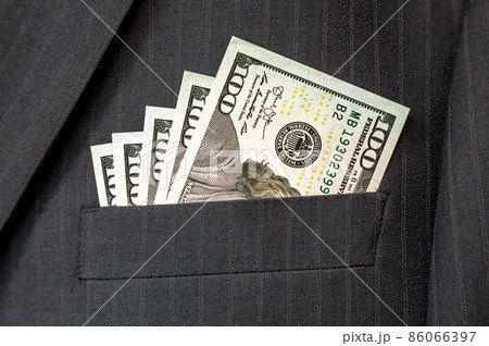 American dollar banknotes in businessman suit pocket American dollar banknotes in businessman suit pocket 86066397