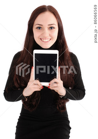 Girl sits on a chair and holding a tablet computer Girl sits on a chair and holding a tablet computer 86066569