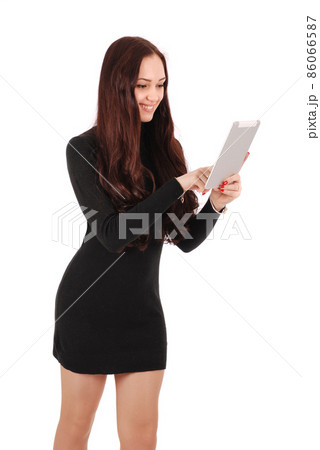 Girl in movement looking at tablet computer Girl in movement looking at tablet computer 86066587