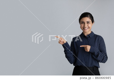 Happy young Indian girl looking at camera Happy young Indian girl looking at camera 86066985