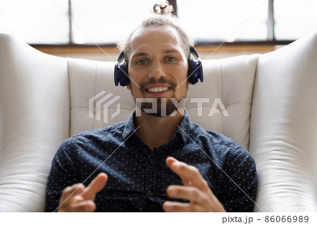 Smiling young handsome man holding video call. Smiling young handsome man holding video call. 86066989