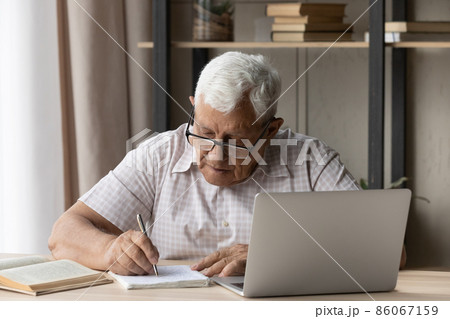 Concentrated old man studying on online courses. Concentrated old man studying on online courses. 86067159