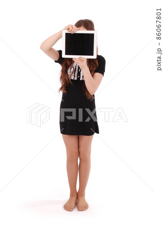 Girl keeps tablet pc in front of face Girl keeps tablet pc in front of face 86067801