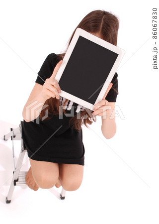 Student teenage girl sitting on the ladder with digital tablet making selfie Student teenage girl sitting on the ladder with digital tablet making selfie 86067830