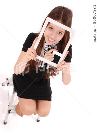 Student teenage girl sitting on the ladder with digital tablet making selfie Student teenage girl sitting on the ladder with digital tablet making selfie 86067831