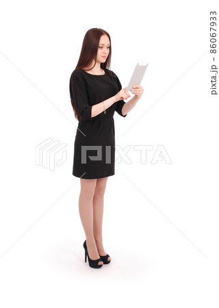 Happy student teenage girl keeps tablet pc standing sideways Happy student teenage girl keeps tablet pc standing sideways 86067933