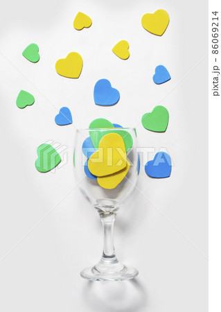 Valentine's Day backgrounds. Multi-colored hearts in a glass, isolated in white 86069214