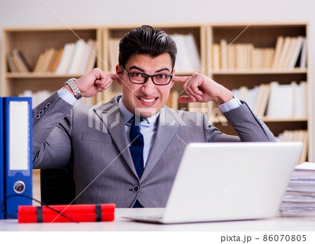 Businessman with dynamite in the office 86070805