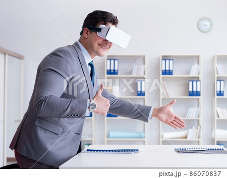 Businessman with virtual reality glasses in the office Businessman with virtual reality glasses in the office 86070837