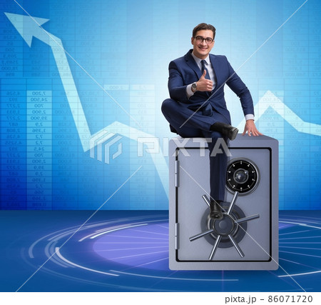Businessman sitting on top of safe Businessman sitting on top of safe 86071720