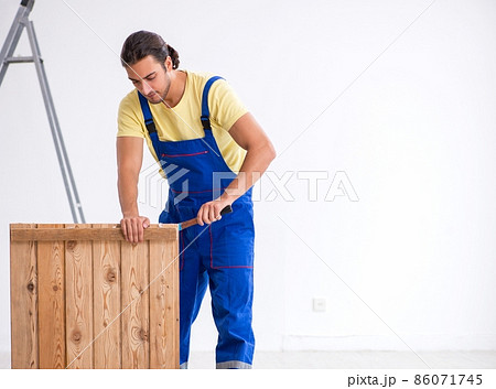 Young male contractor working indoors Young male contractor working indoors 86071745