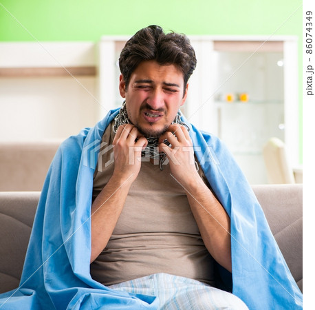 Sick young man suffering from flu at home Sick young man suffering from flu at home 86074349