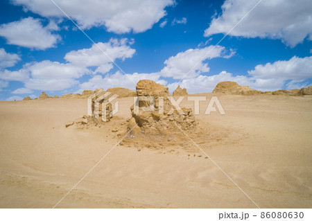 Aerial view of landscape in desert under blue sky Aerial view of landscape in desert under blue sky 86080630