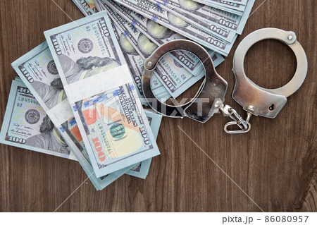 Concept for corruption, fraud and money laundry. Handcuff Concept for corruption, fraud and money laundry. Handcuff 86080957