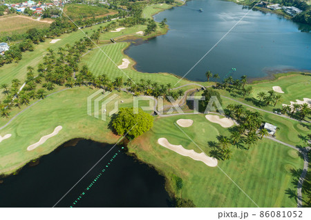 Aerial view of the green golf course in Thailand Beautiful green grass and trees on a golf field with fairway and putting green in summer season 86081052