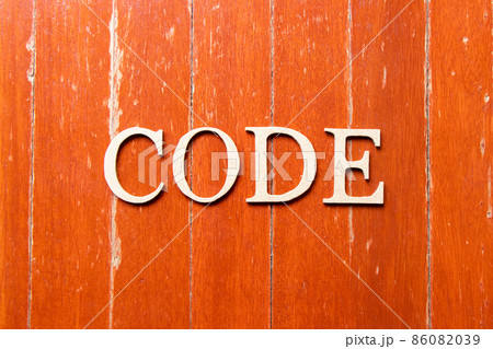 Alphabet letter in word code on old red color wood plate background Alphabet letter in word code on old red color wood plate background 86082039