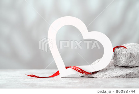 Big white heart shape on gray stones banner 86083744