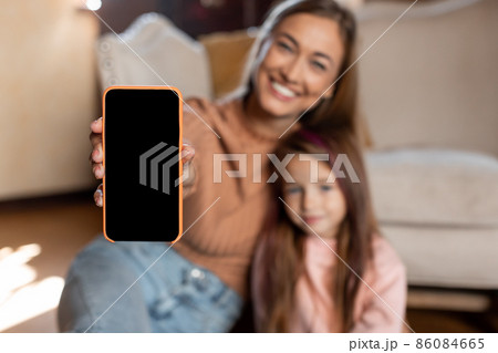 Family showing blank empty smartphone screen for mockup 86084665