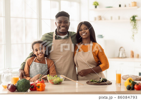 Cheerful Black Family Embracing Cooking Together Standing In Kitchen 86084793