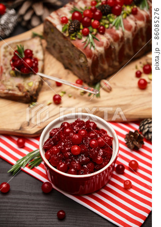 Cranberry sauce with Traditional French terrine on dark wooden background with Christmas decorations Cranberry sauce with Traditional French terrine on dark wooden background with Christmas decorations 86085276