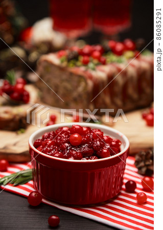 Cranberry sauce with Traditional French terrine on dark wooden background with Christmas decorations 86085291