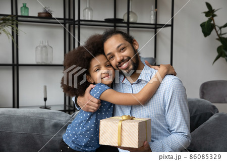 Happy grateful dad hugging adorable teen daughter girl 86085329