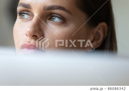 Thoughtful young business woman using laptop computer Thoughtful young business woman using laptop computer 86086342
