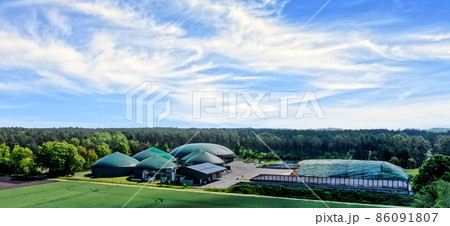 Aerial view of a biogas plant for the production of electrical energy from organic waste and agricultural residues Aerial view of a biogas plant for the production of electrical energy from organic waste and agricultural residues 86091807