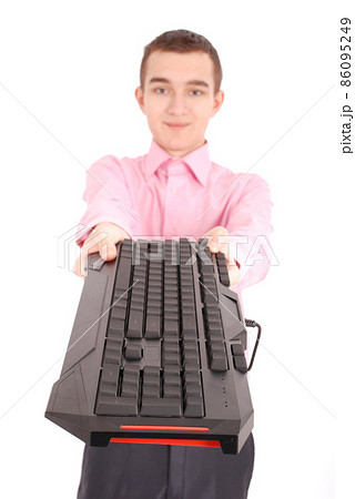 Smiling teenage boy with computer keyboard 86095249