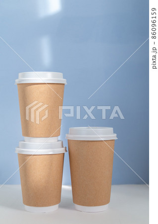group of paper cups against blue background, greenwashing concept 86096159