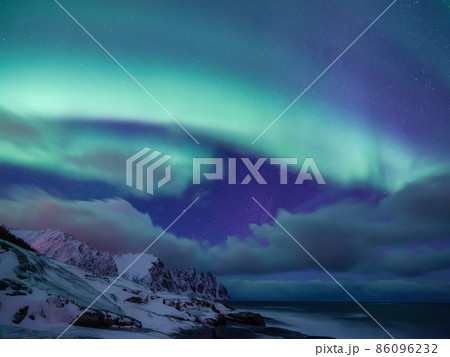 Tungeneset rocks and Aurora Borealis light. Senja islands, Norway. Stars and northern light. Tungeneset rocks and Aurora Borealis light. Senja islands, Norway. Stars and northern light. 86096232