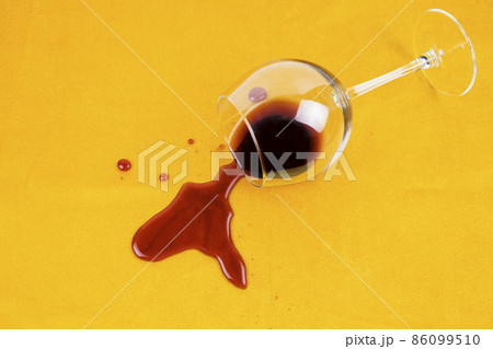 a spilled glass of wine on the tablecloth. Cleaning clothes and furniture from stains. 86099510