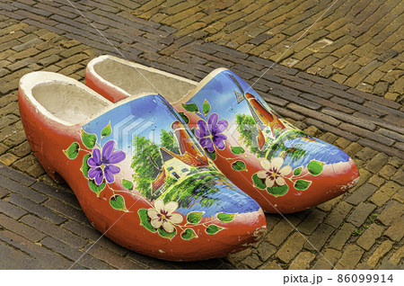 traditional multicolored clogs on a street in the historic center of the city of Breda. Netherlands. traditional multicolored clogs on a street in the historic center of the city of Breda. Netherlands. 86099914
