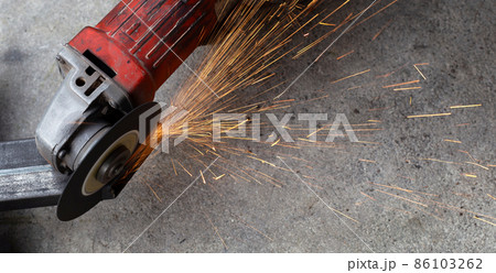 Close up angle grinder. Iron gate repair Close up angle grinder. Iron gate repair 86103262