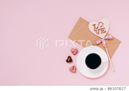 Chocolates festive box cup of coffee, hearts, an envelope pink background. Festive composition for Valentine's Day Chocolates festive box cup of coffee, hearts, an envelope pink background. Festive composition for Valentine's Day 86107627