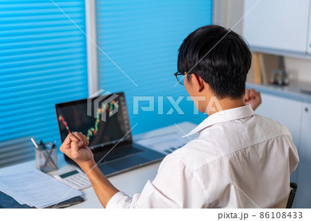 Overwork Concept The man sitting at the desk in the office raising his hand with happy emotion Overwork Concept The man sitting at the desk in the office raising his hand with happy emotion 86108433
