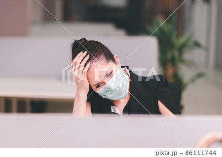 Asian woman have a migraine during working at office,Female suffering from headache Asian woman have a migraine during working at office,Female suffering from headache 86111744