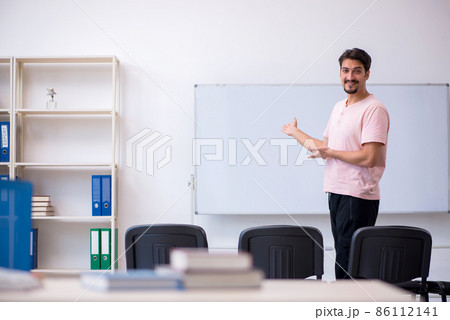 Young male teacher in the classroom during pandemic Young male teacher in the classroom during pandemic 86112141