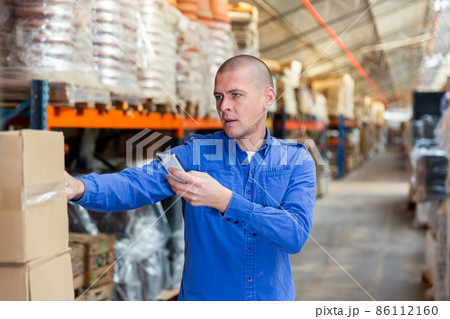 Fulfillment center worker using smartphone in his work 86112160