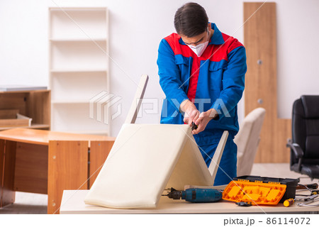 Young male carpenter working in the office during pandemic Young male carpenter working in the office during pandemic 86114072