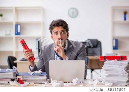 Young male employee and too much work in the office 86115805