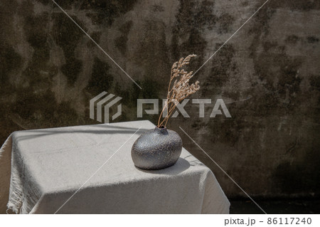 Dried flowers in Handmade Ceramic Vases on table. 86117240